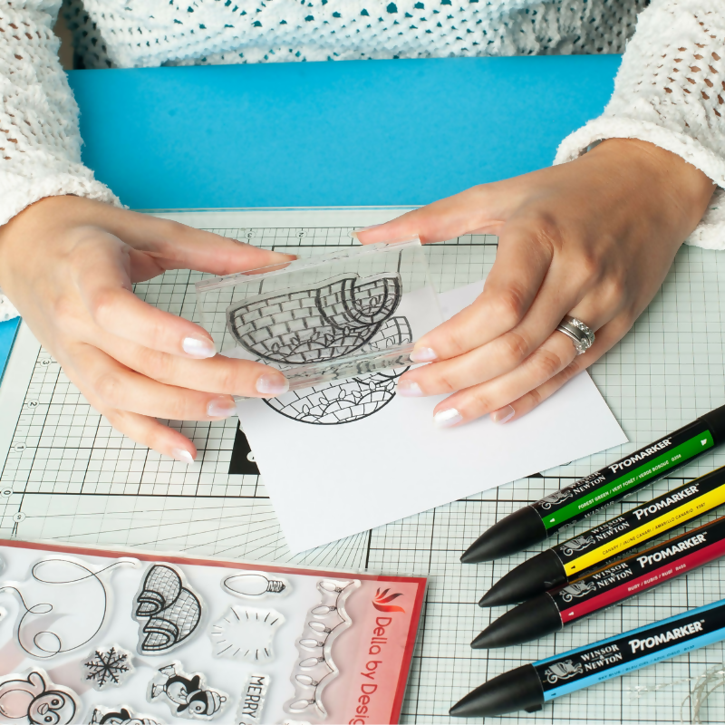 Della by Design Christmas being stamped