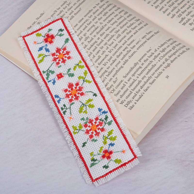 Trimits Floral Cross Stitch Bookmark Kit on a book